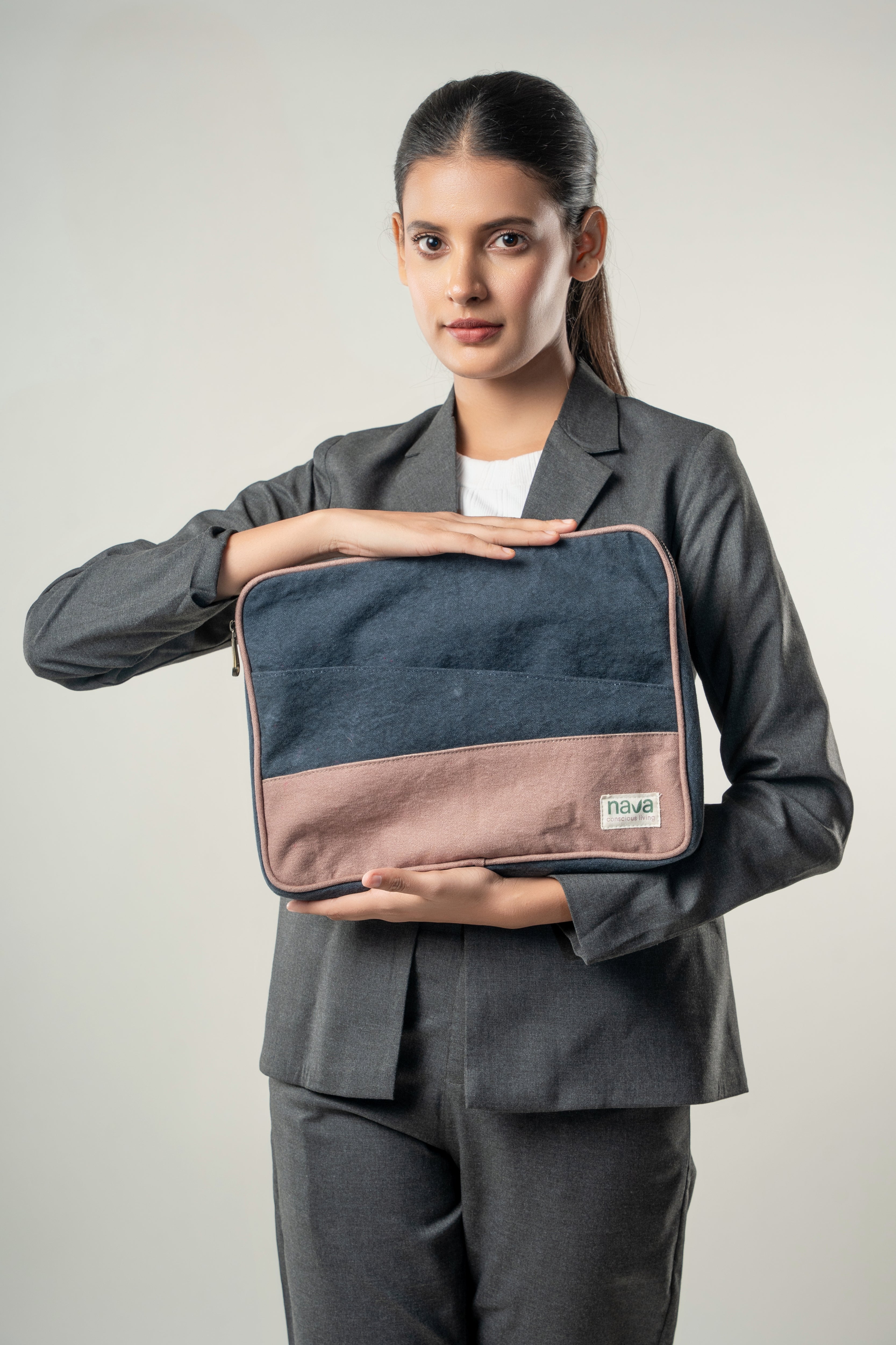 Woman holding a dual tone Nava branded laptop sleeve